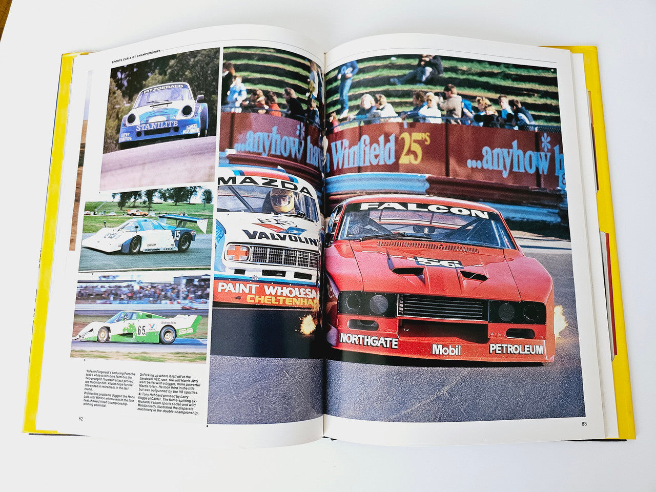 Open motoring magazine spread with colorful race cars and event signage