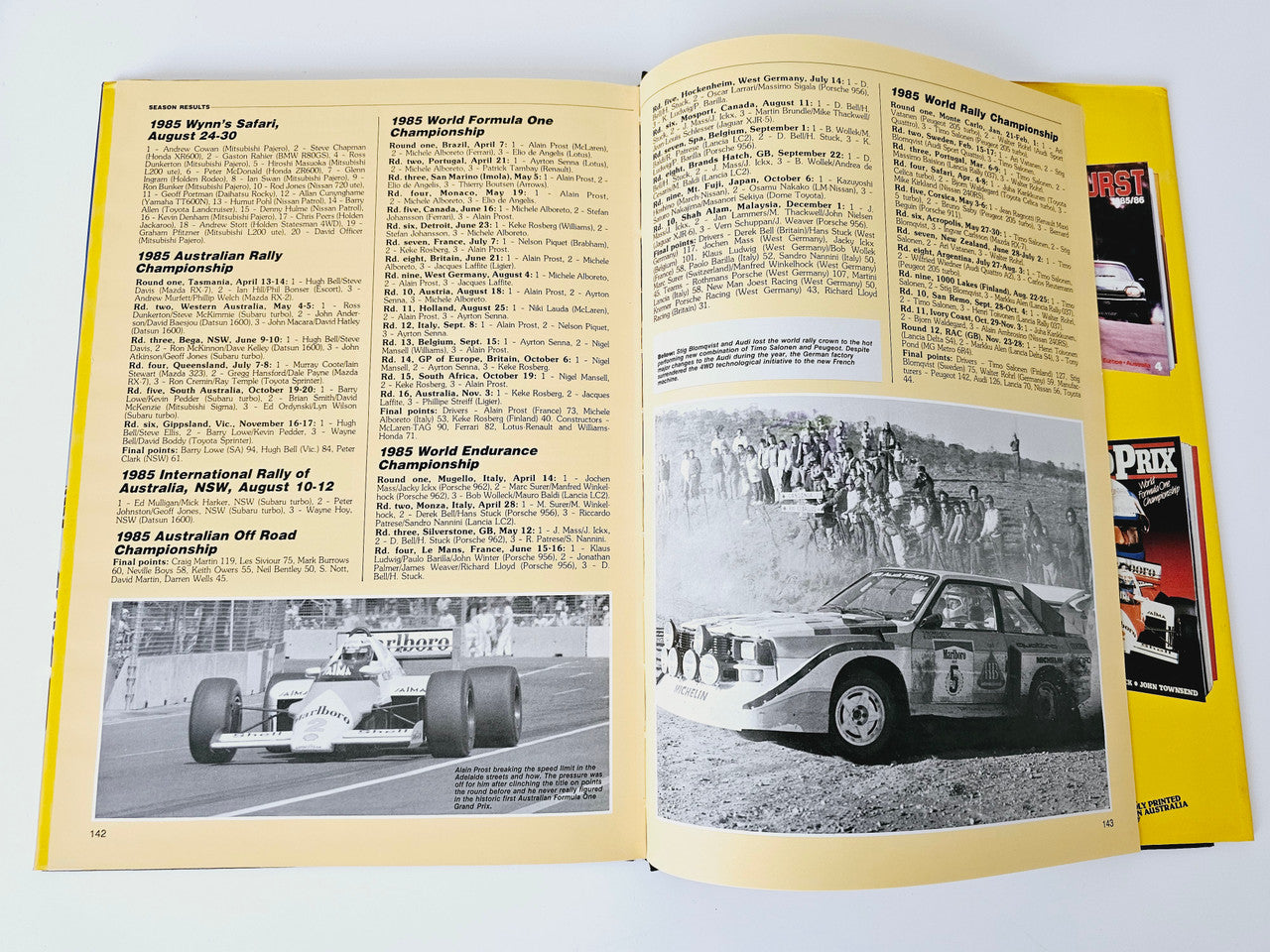 Open motoring magazine spread with race results text and black-and-white car photo