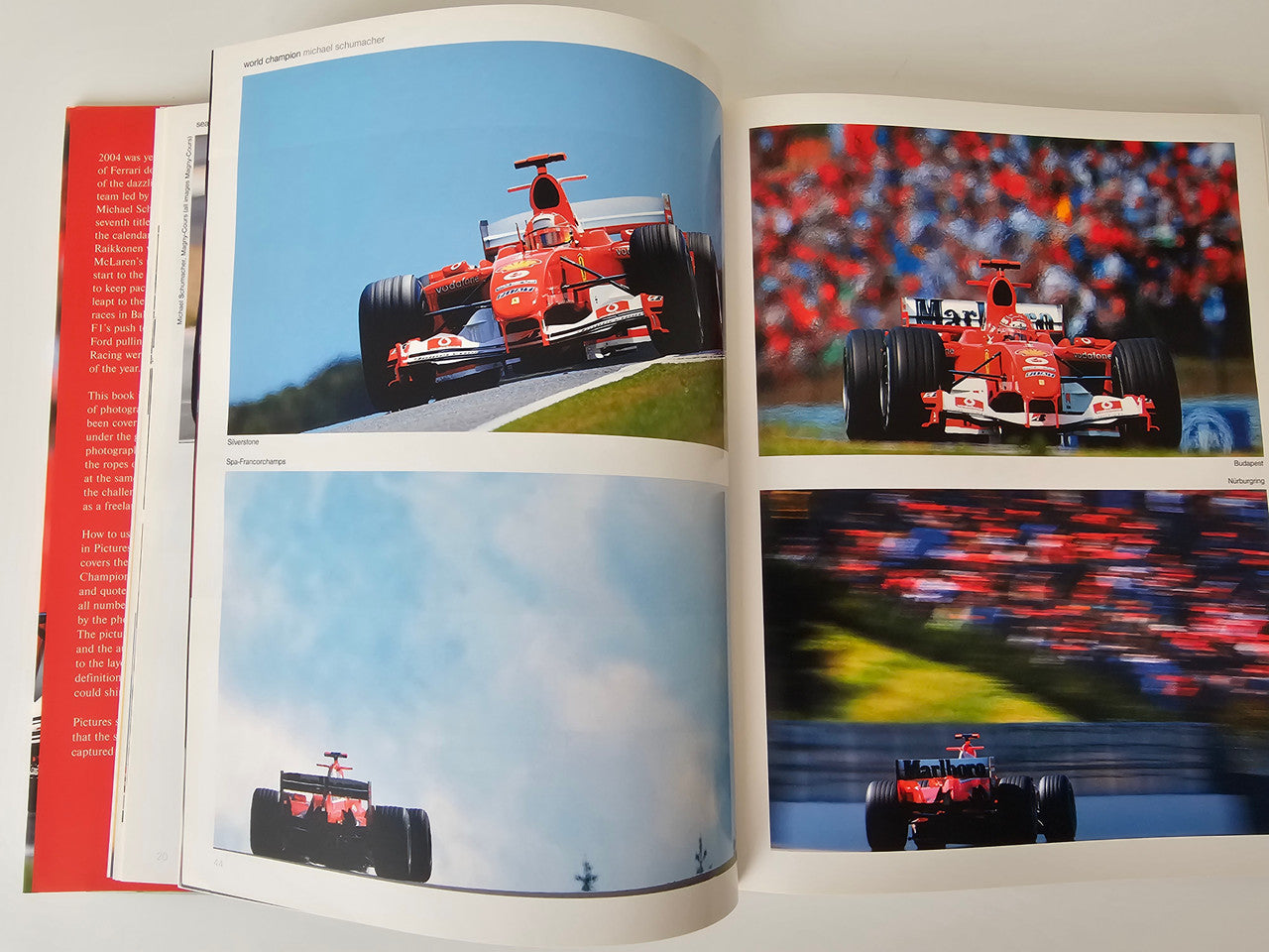 Motorsport photo book open to racing car images on two page spreads