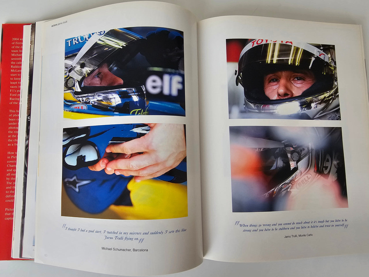 Motorsport photo book open to driver helmet portraits and race team images