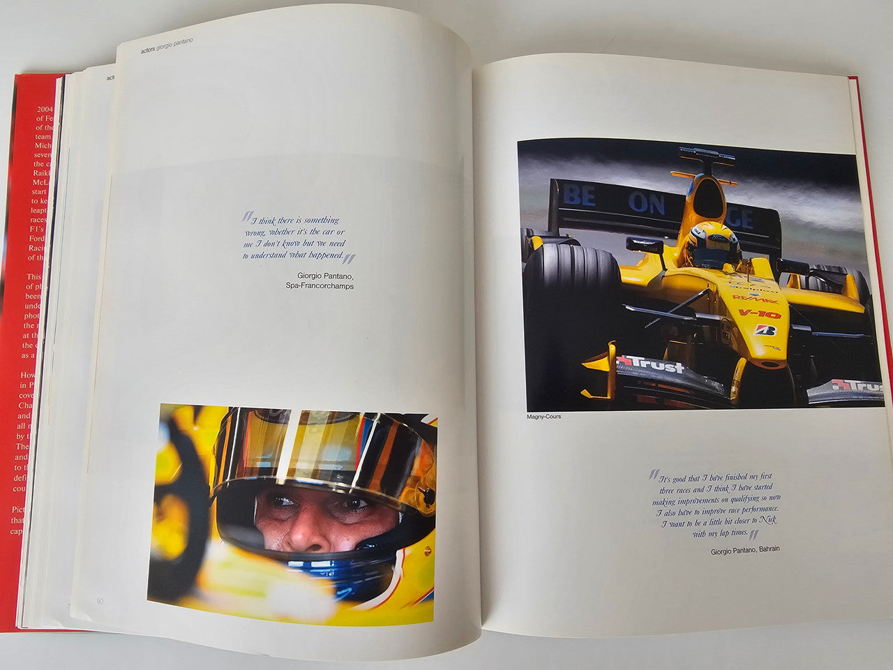 Motorsport photo book open to driver and race car pictures with captions