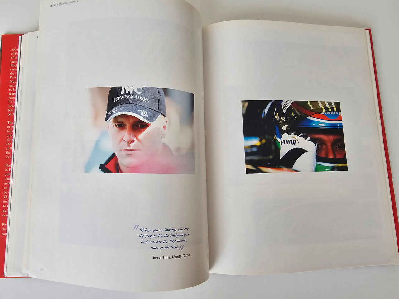 Motorsport photo book open to two driver portraits with surrounding race imagery