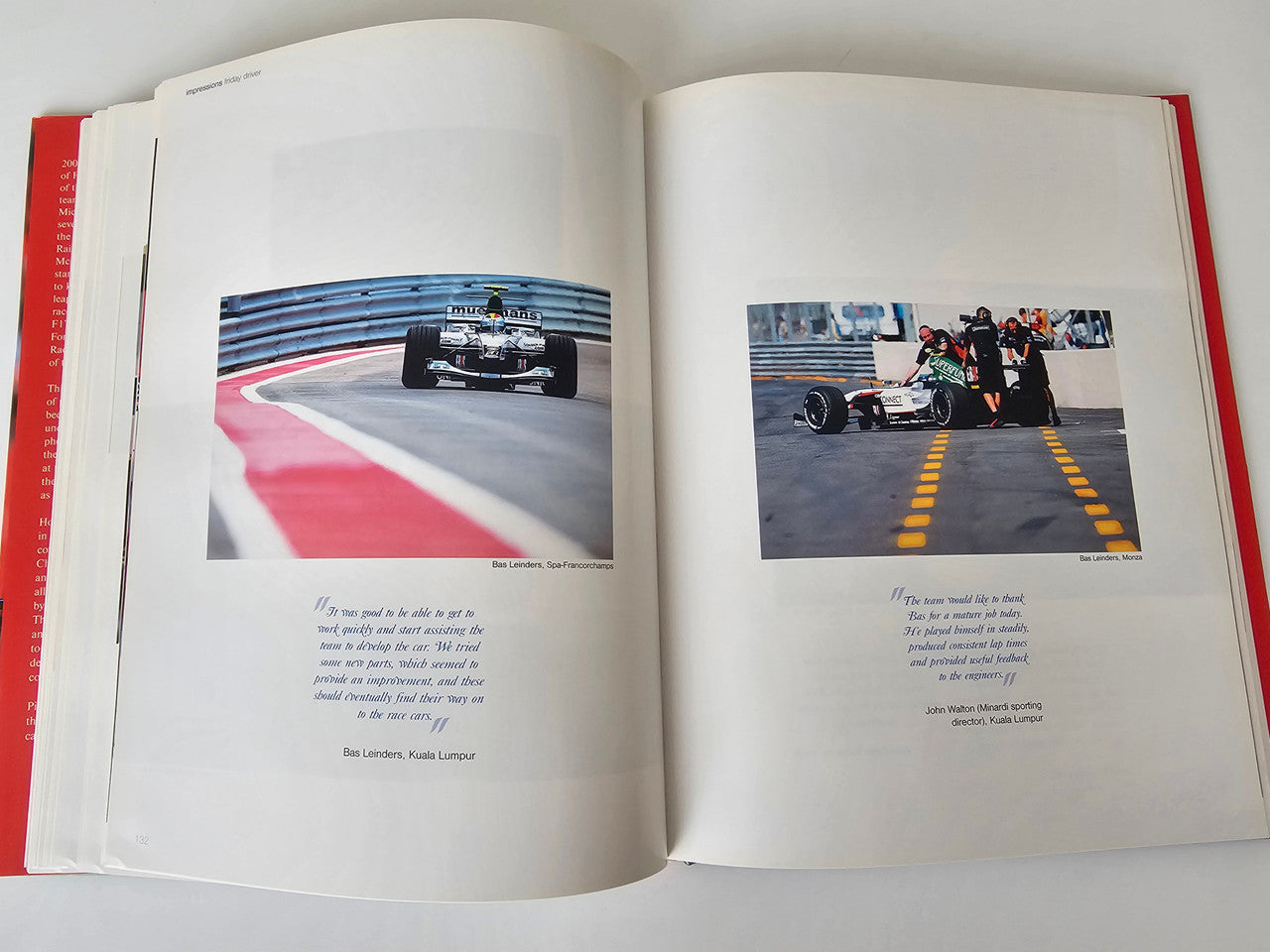 Motorsport photo book open to track racing photos on left and right pages