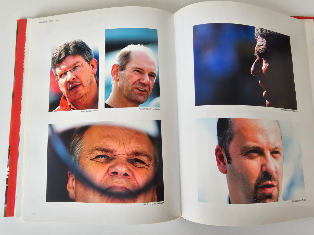 Photo book open spread with multiple face portraits of racing drivers