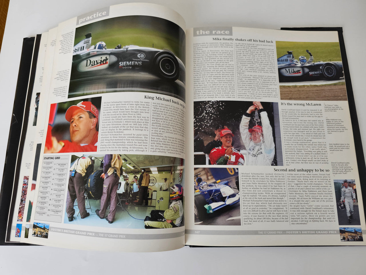 Open motorsport yearbook with driver portraits, interviews, and race action photos