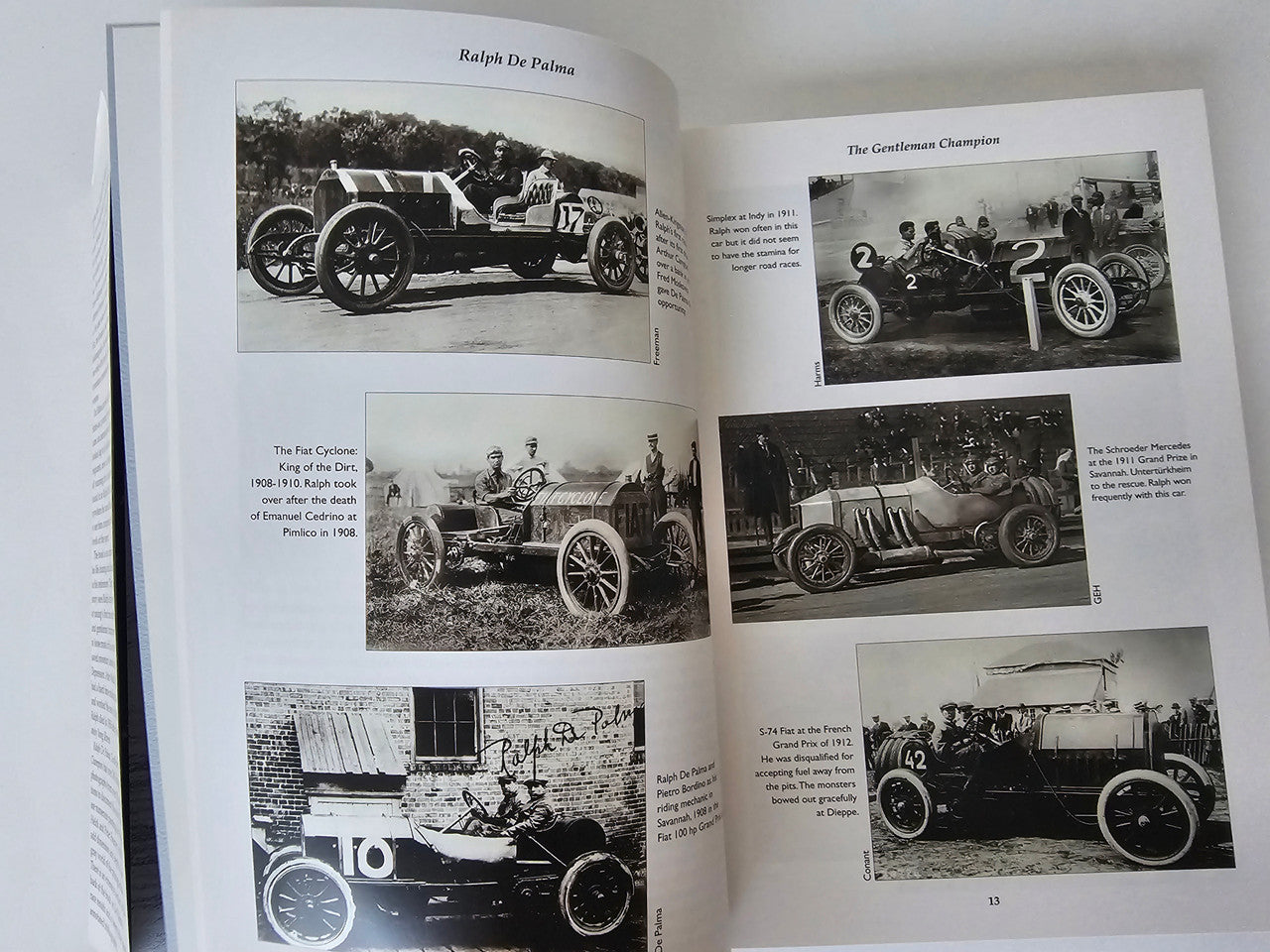 Open book spread with multiple vintage car photographs and caption text