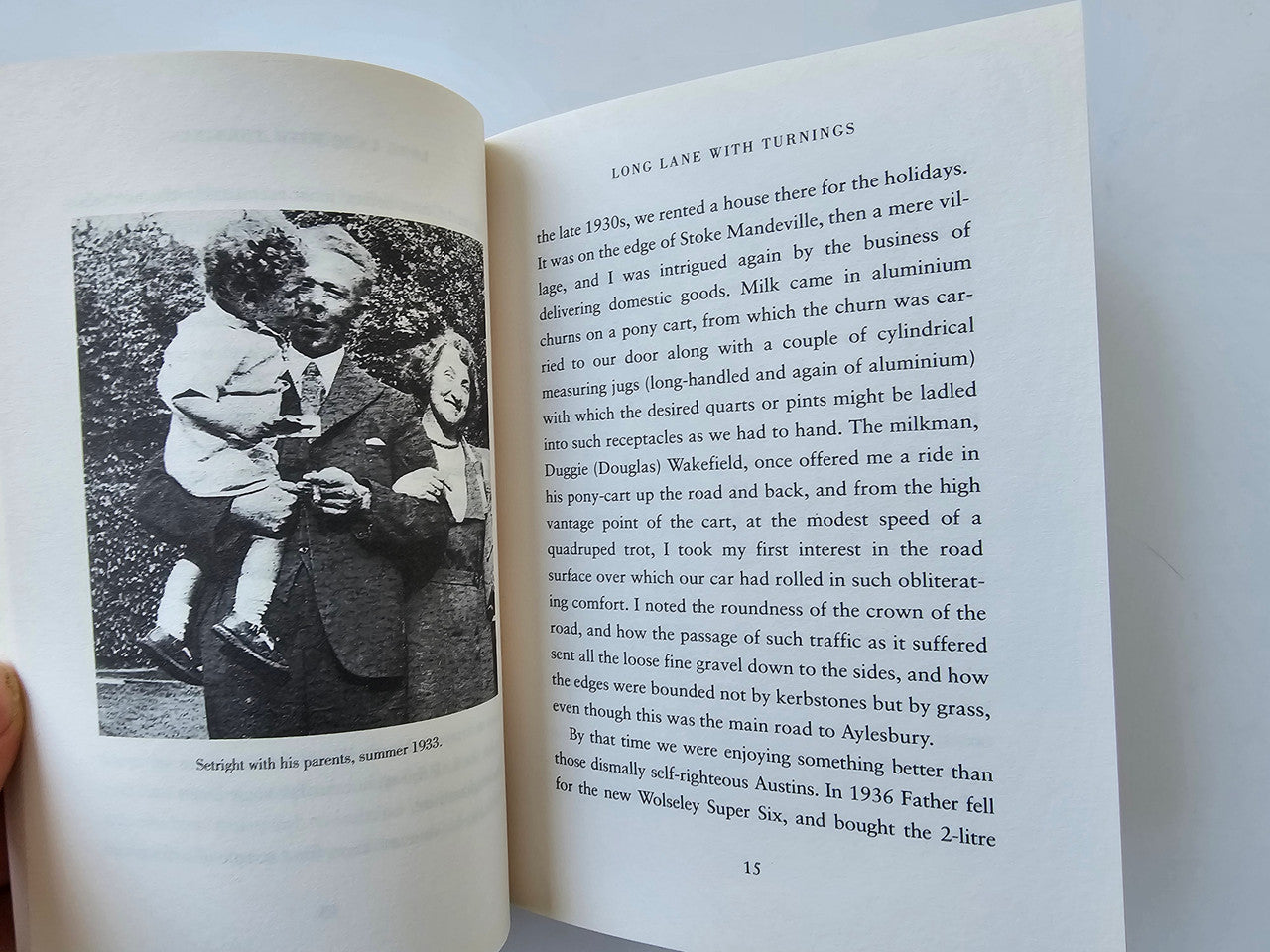 Open book page with black-and-white portrait photo and printed text