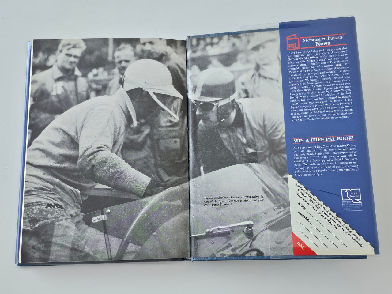 Open racing driver book pages with grayscale driver photos and a blue text panel on right.