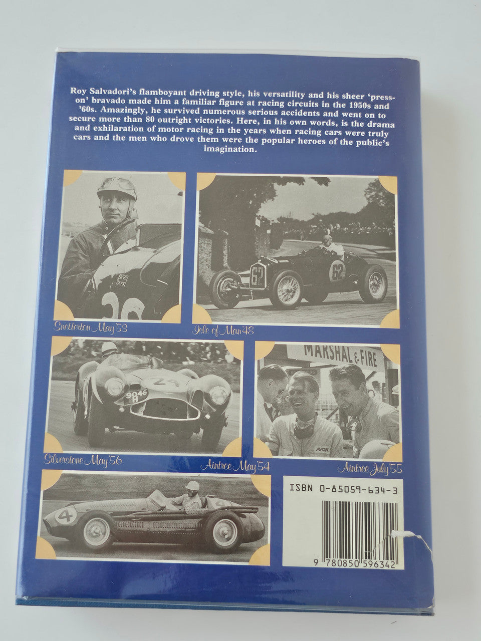 Racing driver book back cover with collage of driver and car photos and block text.