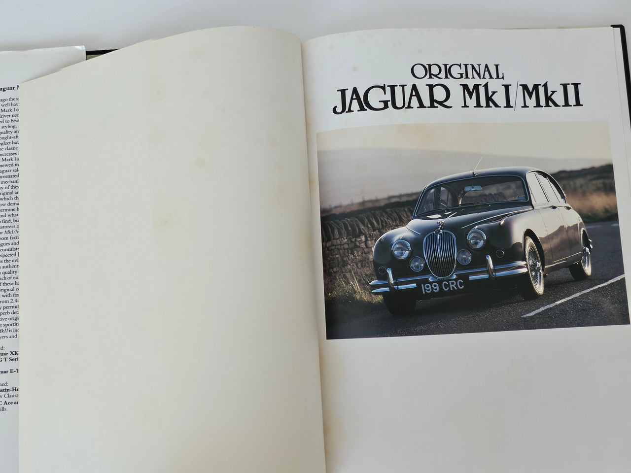 Open Jaguar MkI/MkII restorer’s guide book showing cover page artwork