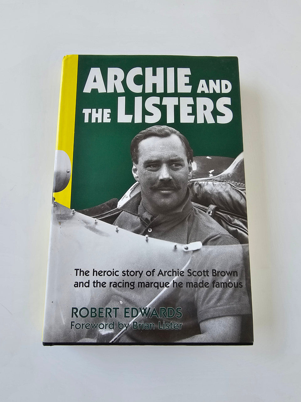 Signed racing biography book cover with portrait of Archie Scott Brown