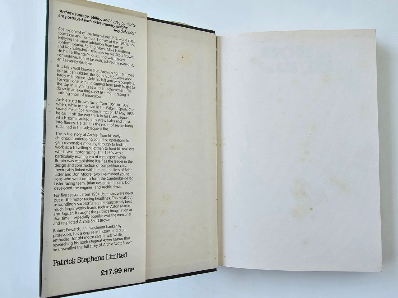 Open book with biography text page on the left and blank page on the right