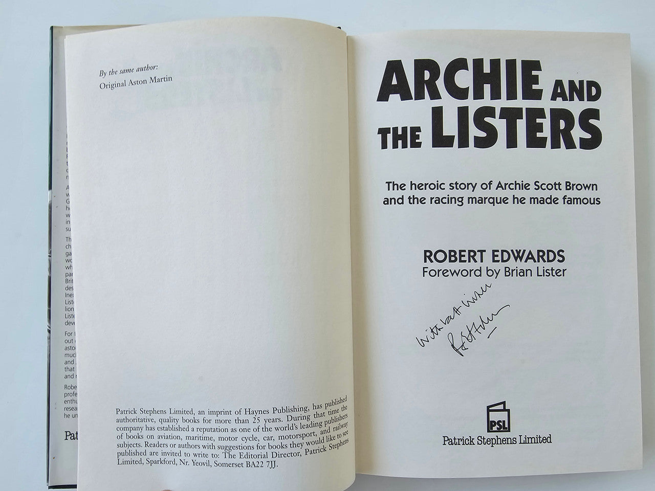 Open book showing front matter with cover title text, author name, and signature