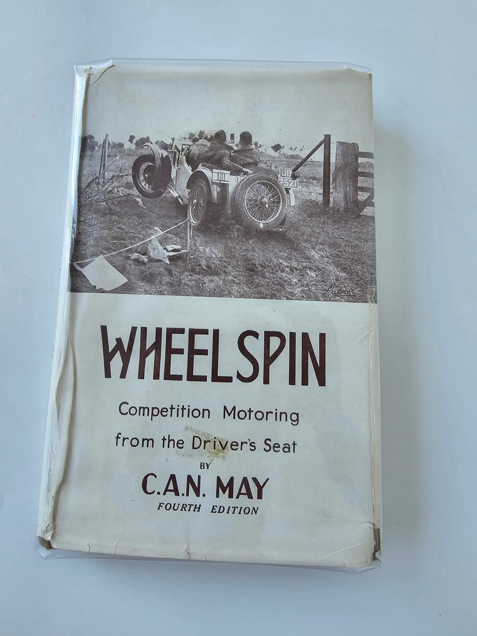 Vintage automotive book with white cover and bold Wheelspin title text