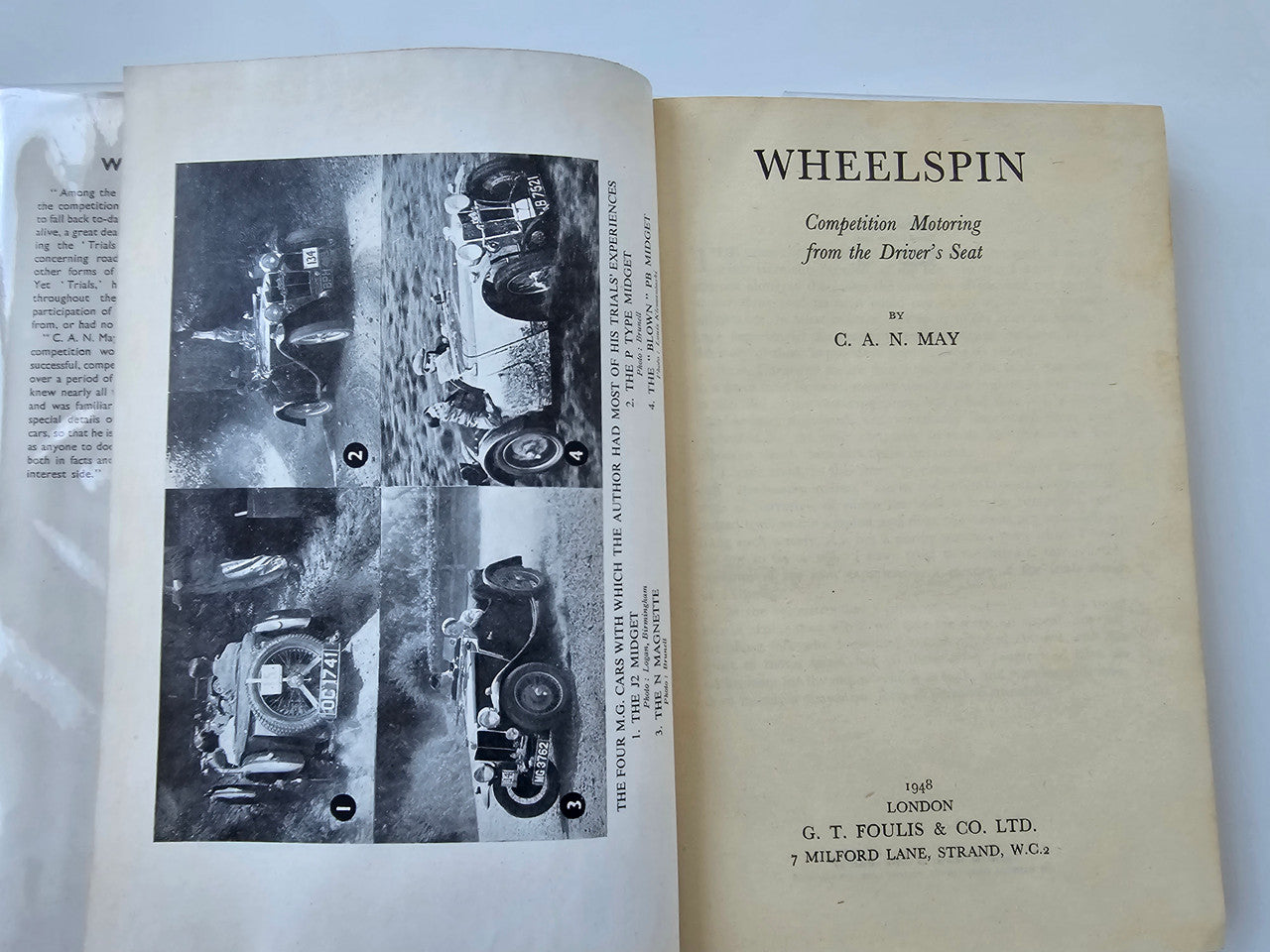 Vintage automotive book open to title and photo plates inside pages