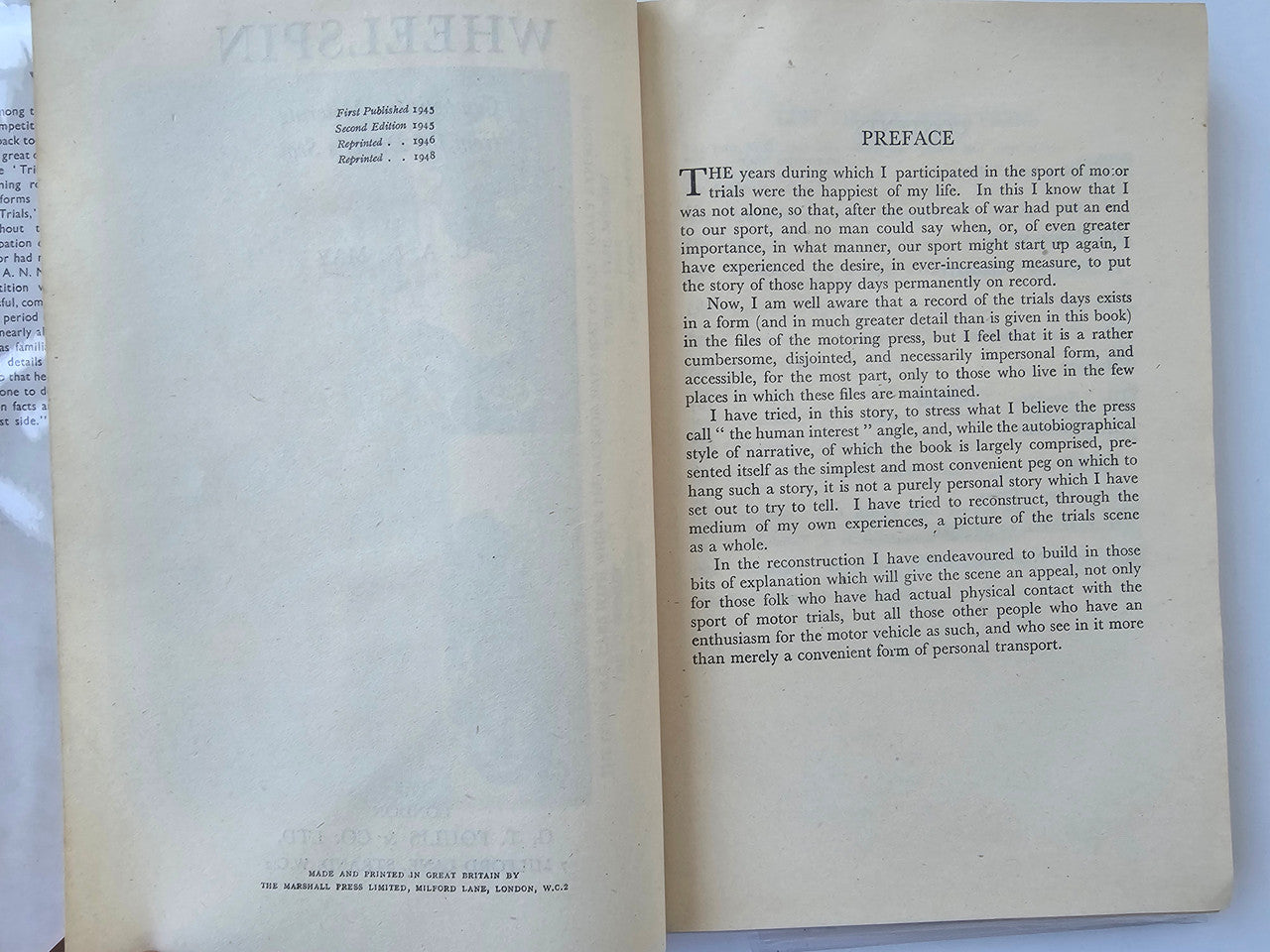 Vintage automotive book open to preface page with printed text and heading