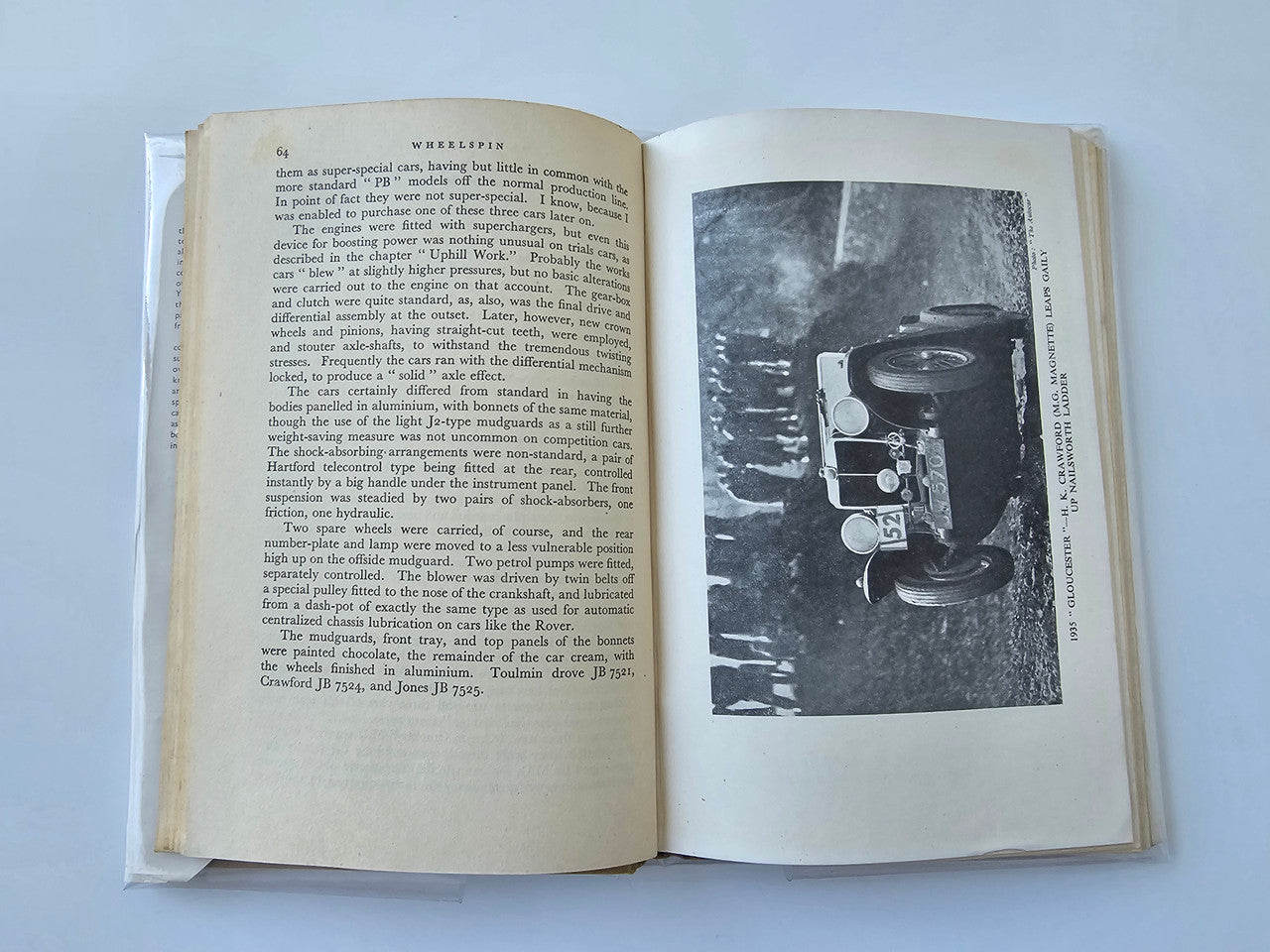Vintage automotive book open to text page with inset black-and-white vehicle image