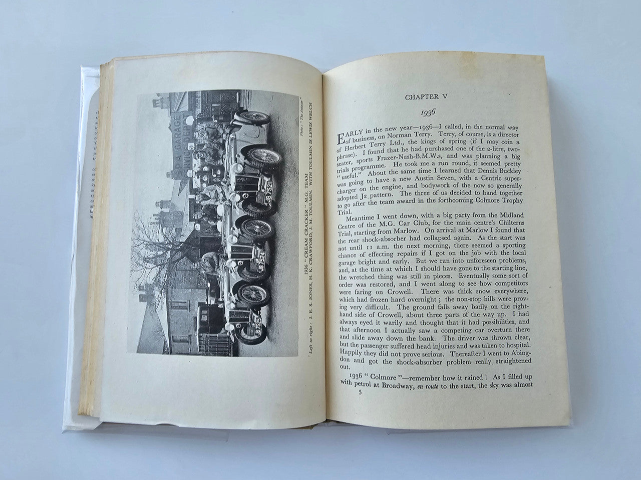 Vintage automotive book open to chapter page with black-and-white vehicle lineup