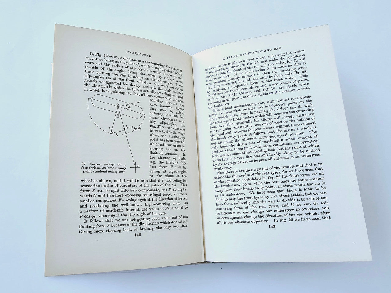 Racing Driver book open to text pages with a small diagram and figure labels