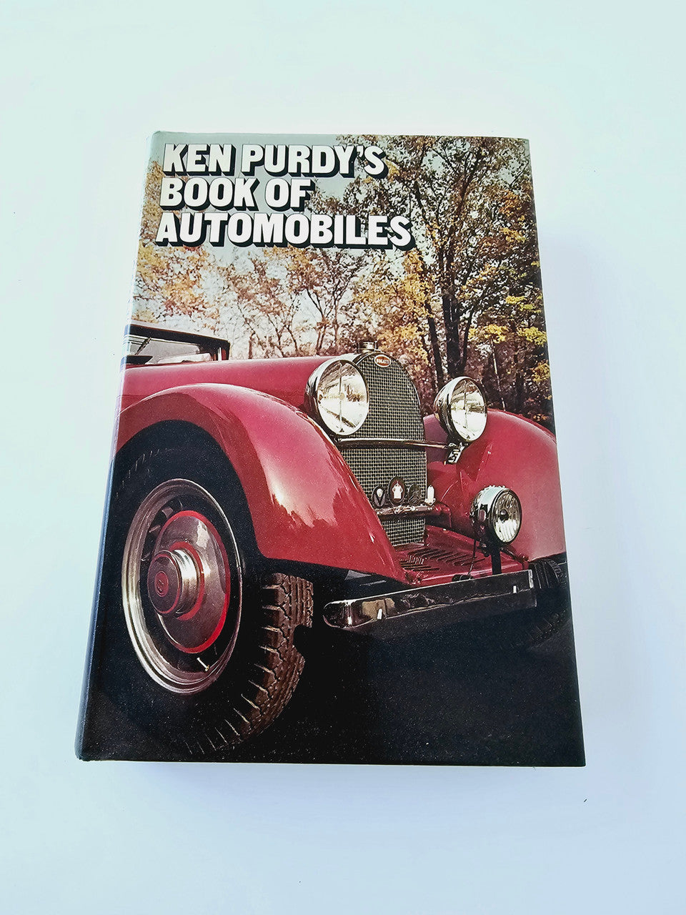 Automobile book with red classic car on cover and title text near top