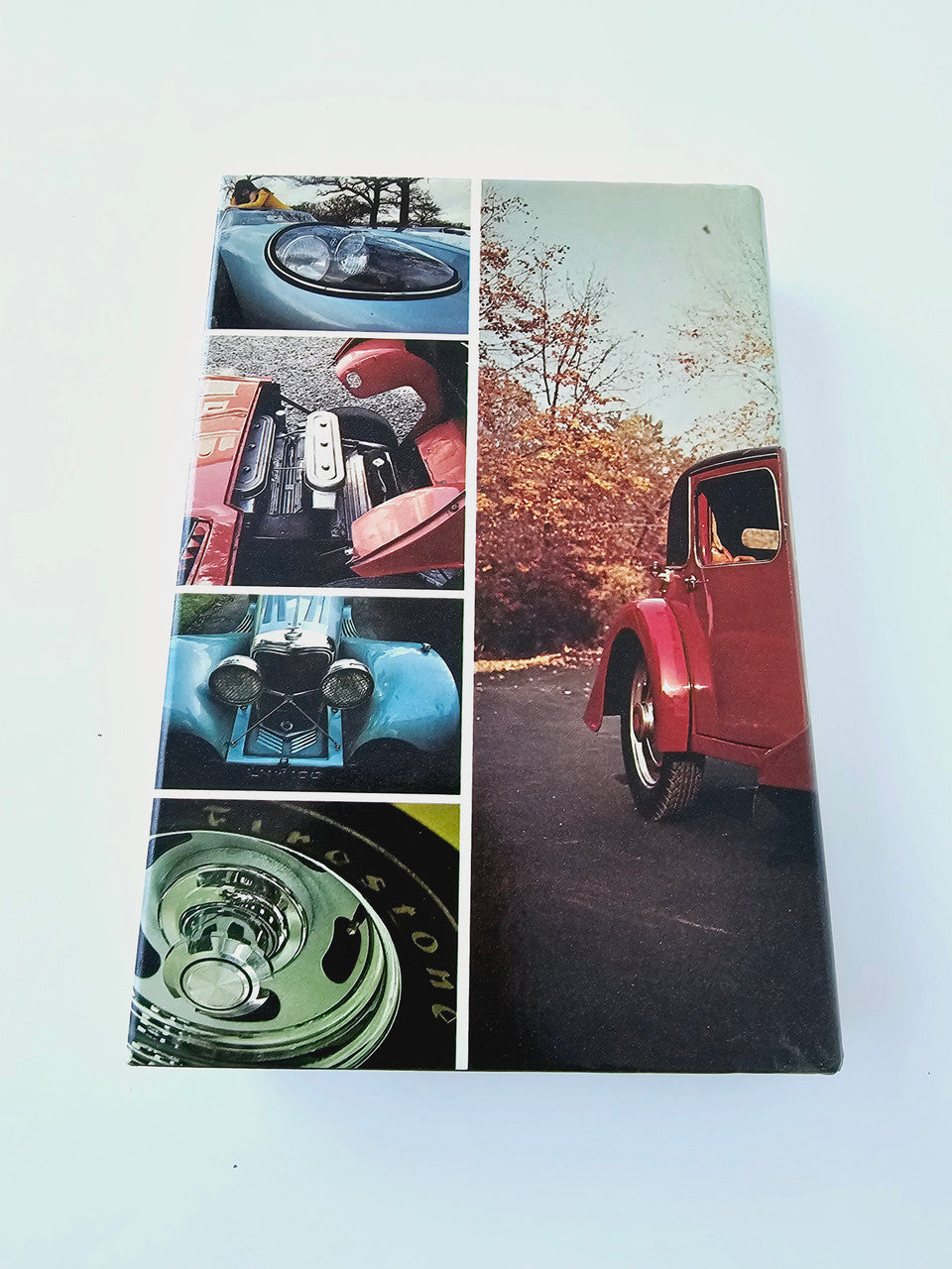Automobile book cover with a collage of red car, dashboard, wheels, and headlight