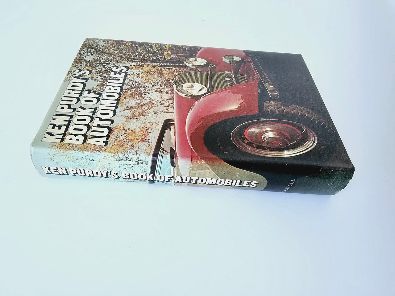 Automobile book with red classic car image on hardcover and title on side panel