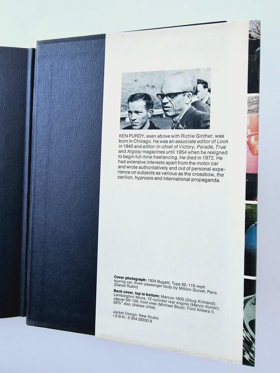 Automobile history book with photo and caption on back cover; dark blue cloth spine.