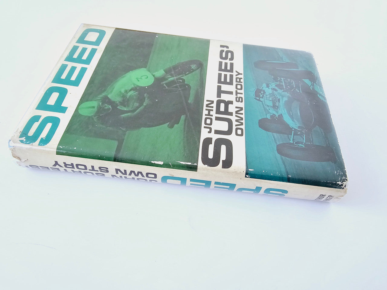 Motorsport book in clear cover, "SPEED" and "John Surtees' Own Story" printed on box