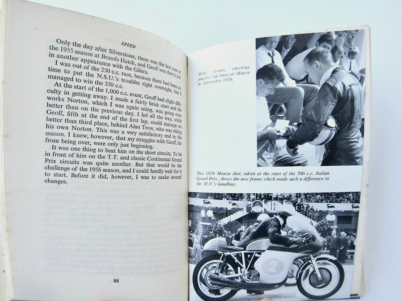 Motorsport memoir book open, text page with black-and-white race photos on the right