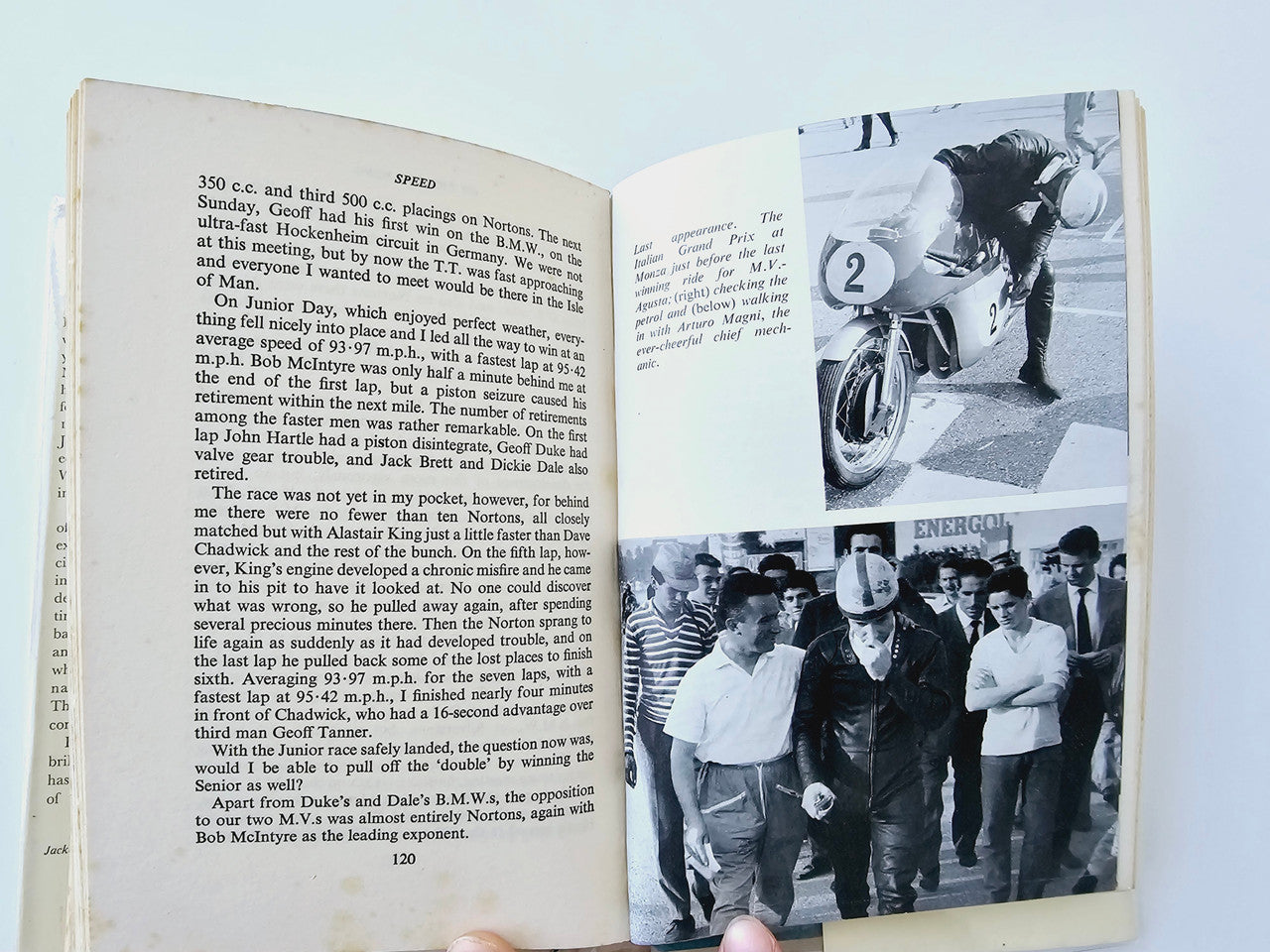 Motorsport memoir book open, text page with black-and-white event photos and page numbers