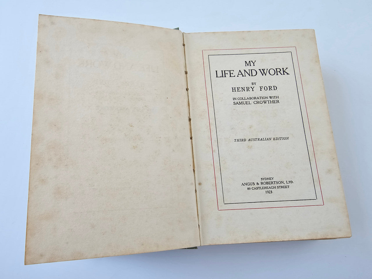 Open book with printed title page on the right, worn off-white paper.