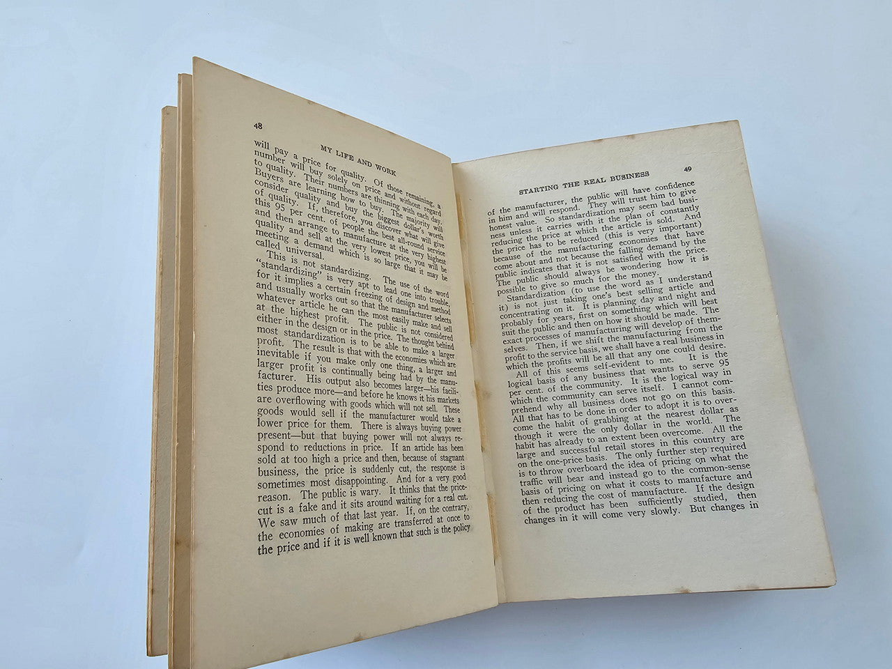 Open book spread with more chapter text blocks, off-white pages with light staining.