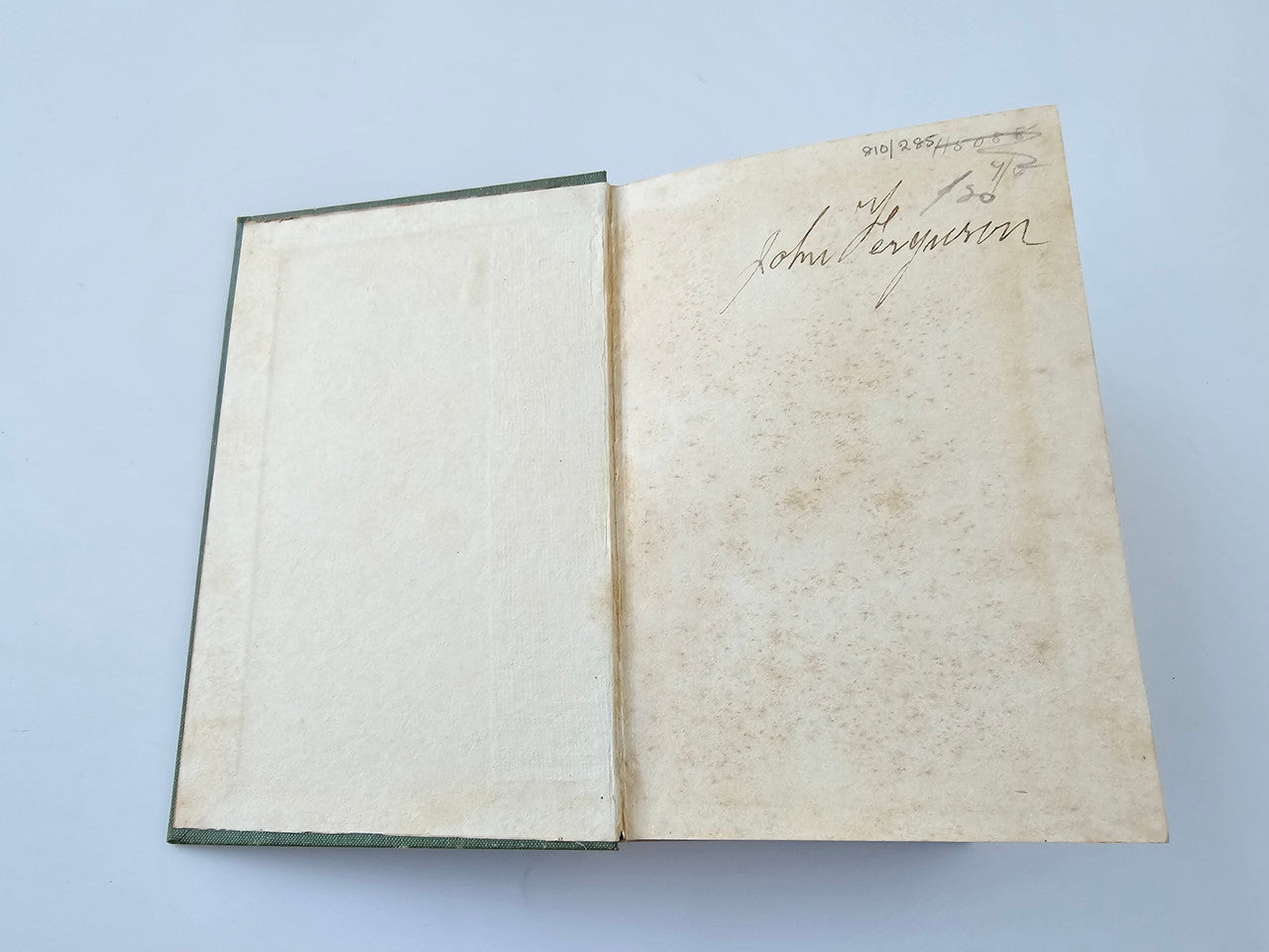 Open book with off-white inside pages, no readable text on the left side.