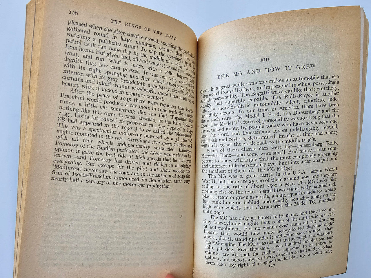 Vintage book open pages with numbered sections and dense black paragraphs