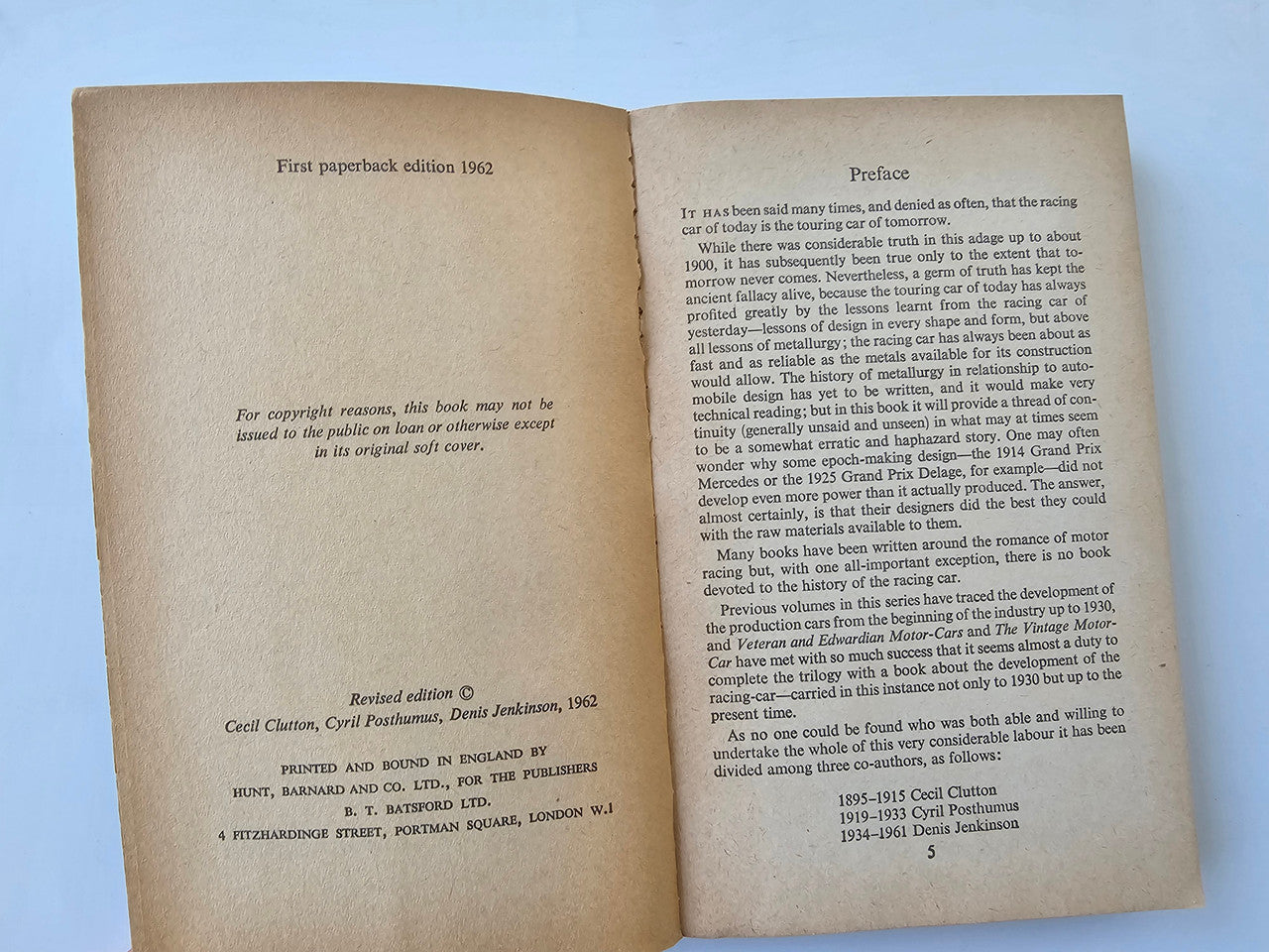 Open book with preface and edition information text on beige pages