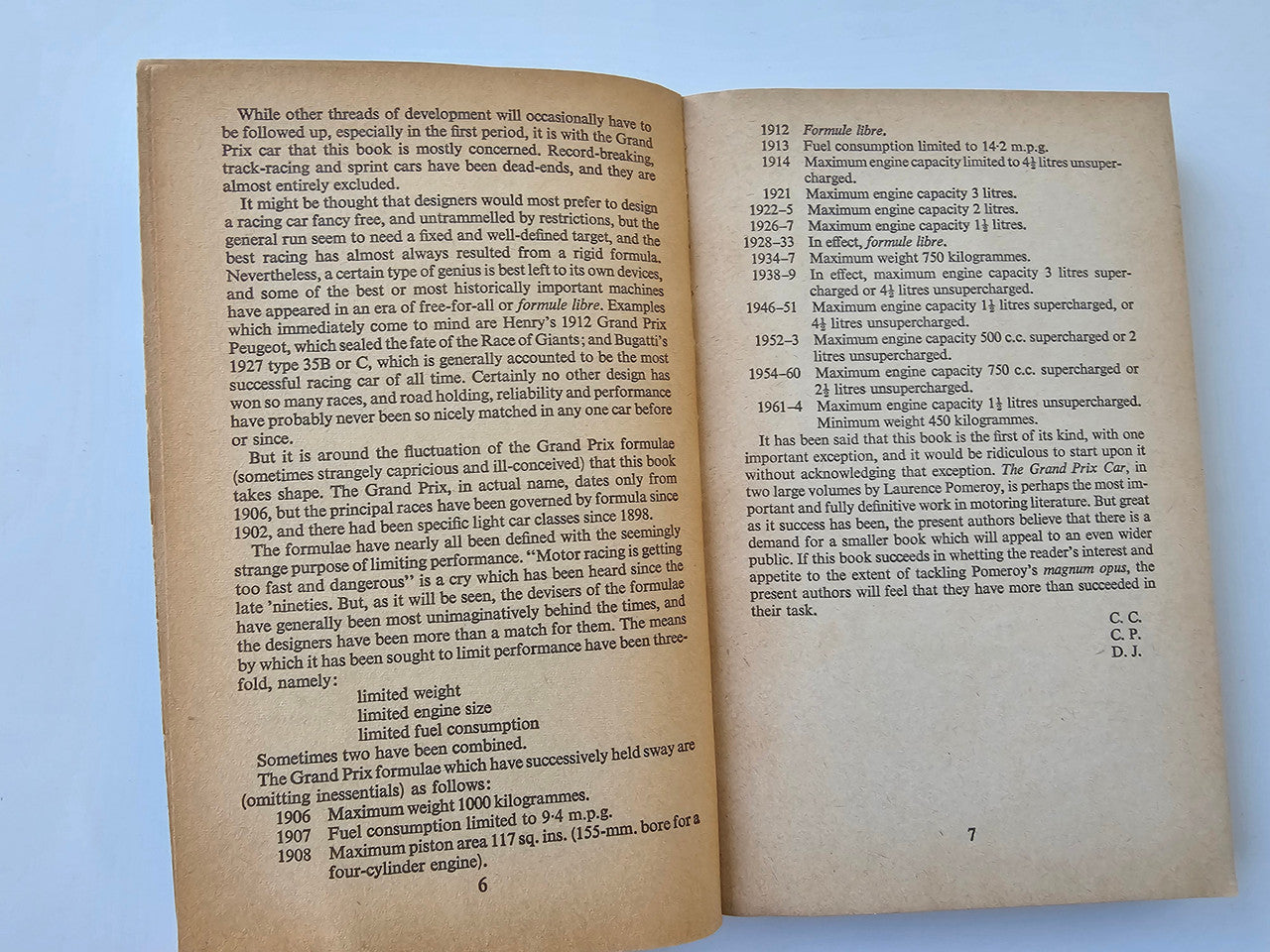 Open book spread with dense text columns and page numbers on beige paper