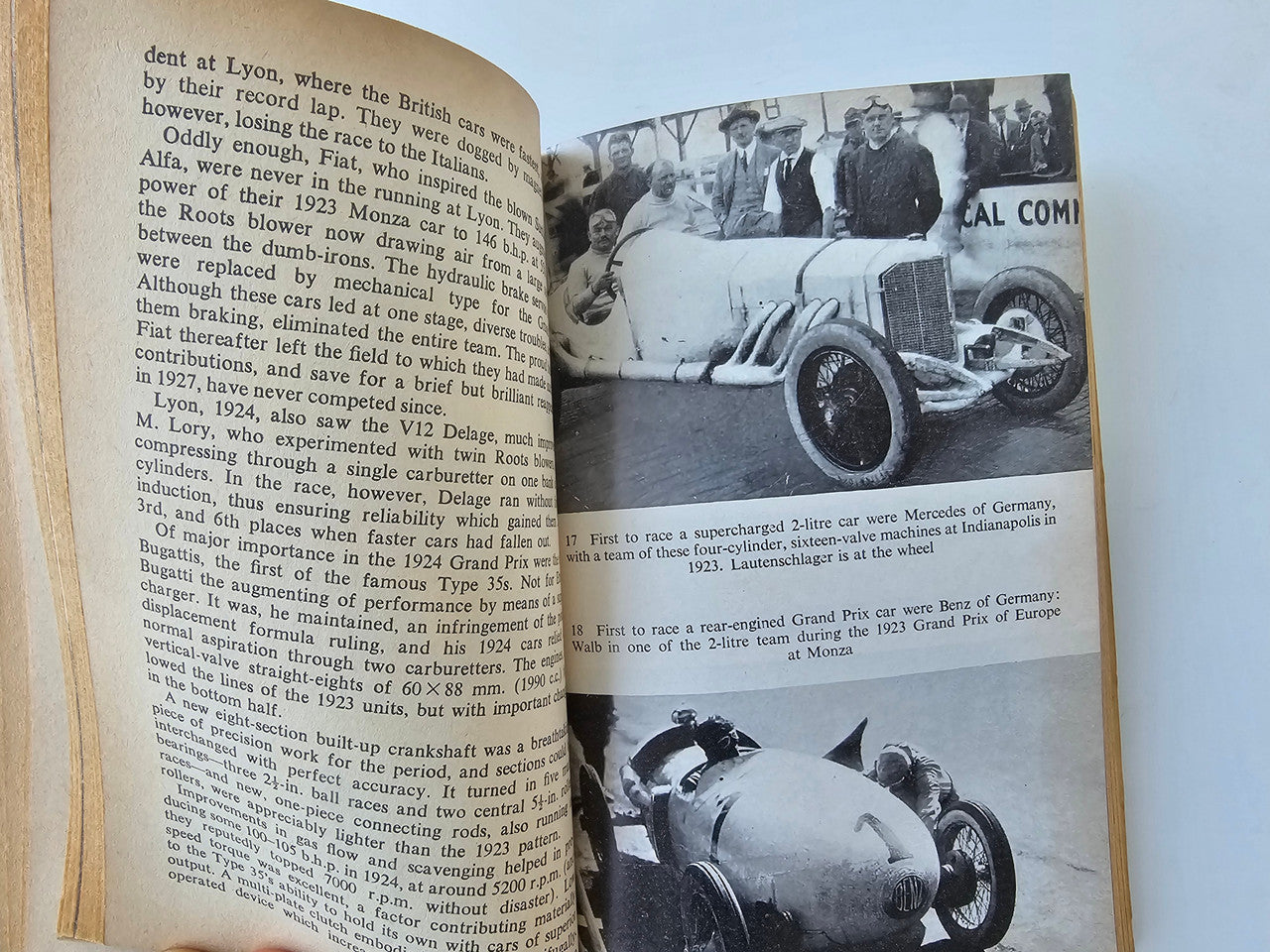 Open book spread with black-and-white racing photos and dense text