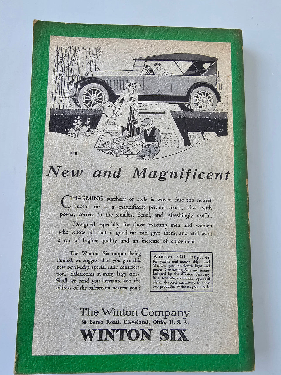 Vintage Winton Six advertisement page with illustrated car scene and product description.