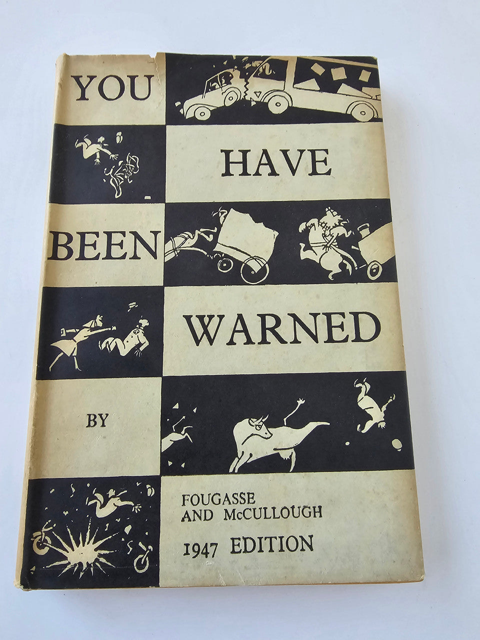 Vintage hardcover book with black-and-cream checkerboard “You Have Been Warned” cover