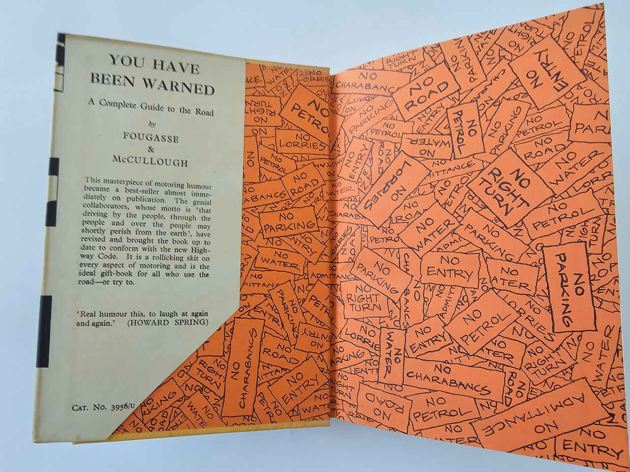 Vintage book open: left title page and orange “No Entry” style map endpaper