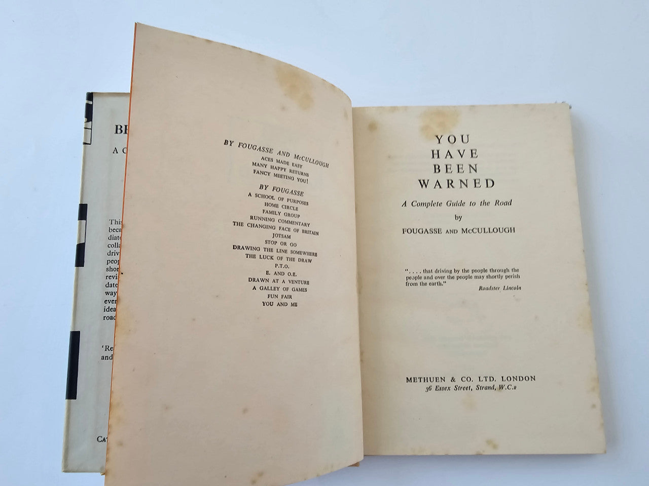 Vintage book open to title pages with text and publisher information