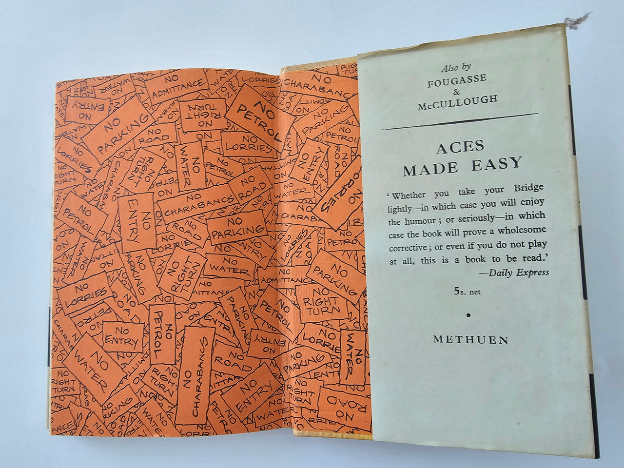 Vintage book open: orange map-pattern endpaper and “Aces Made Easy” page