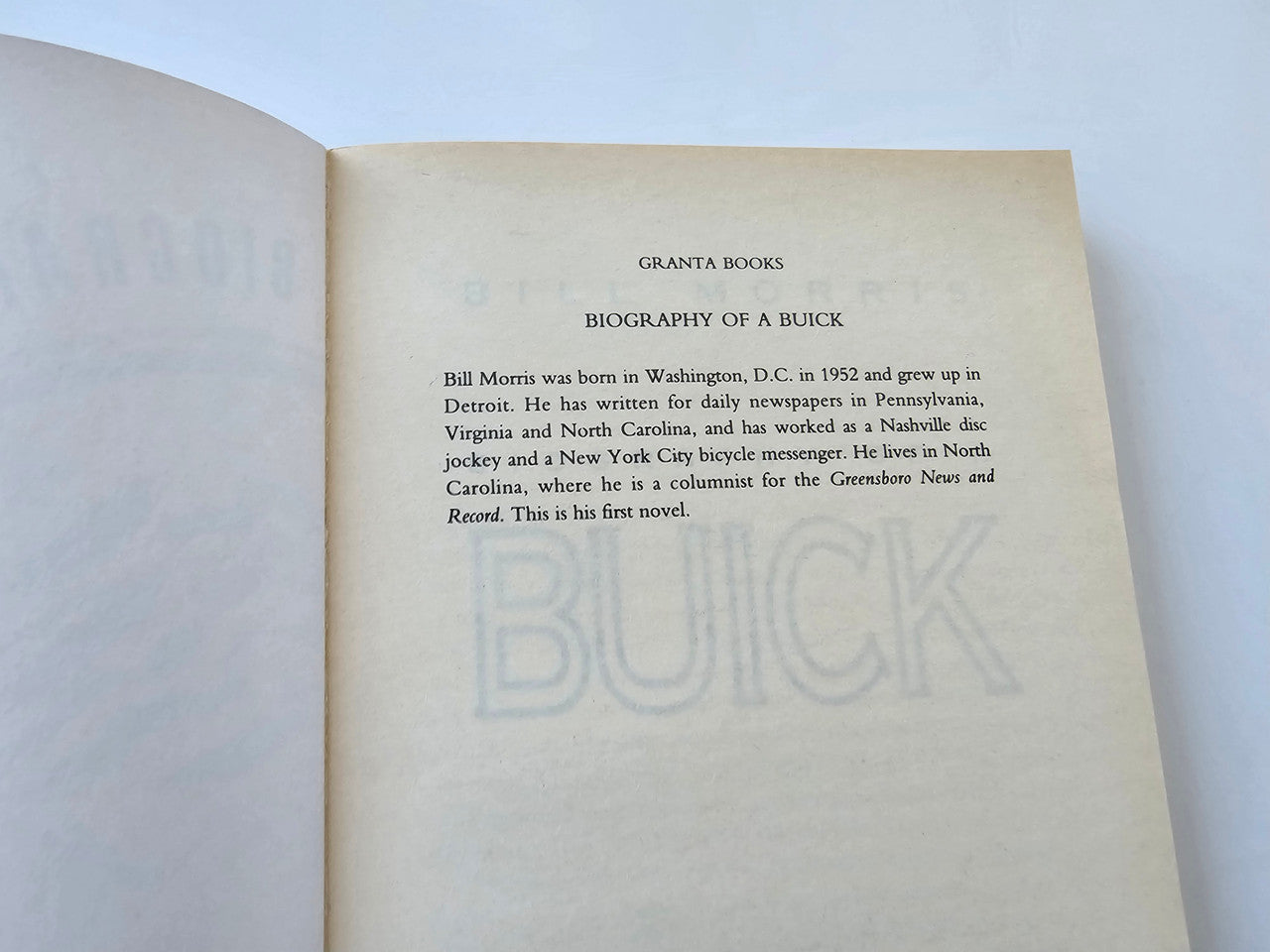 Biography book open to title page with centered text on cream paper