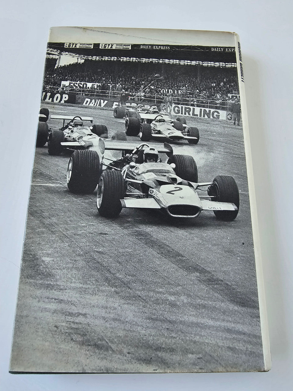 Book with black-and-white Formula cars on track on the front cover