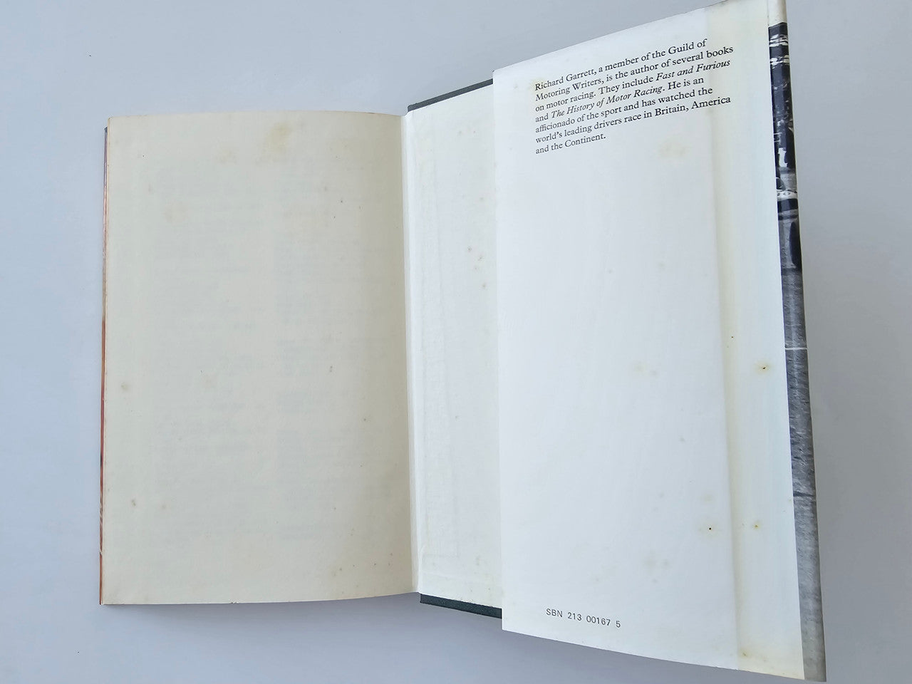 Open book with blank cream pages, visible spine and page edges