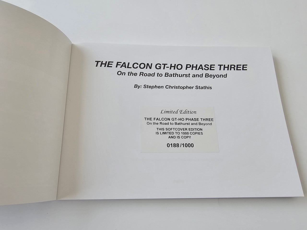 Limited edition automotive book open showing author and limited edition number slip