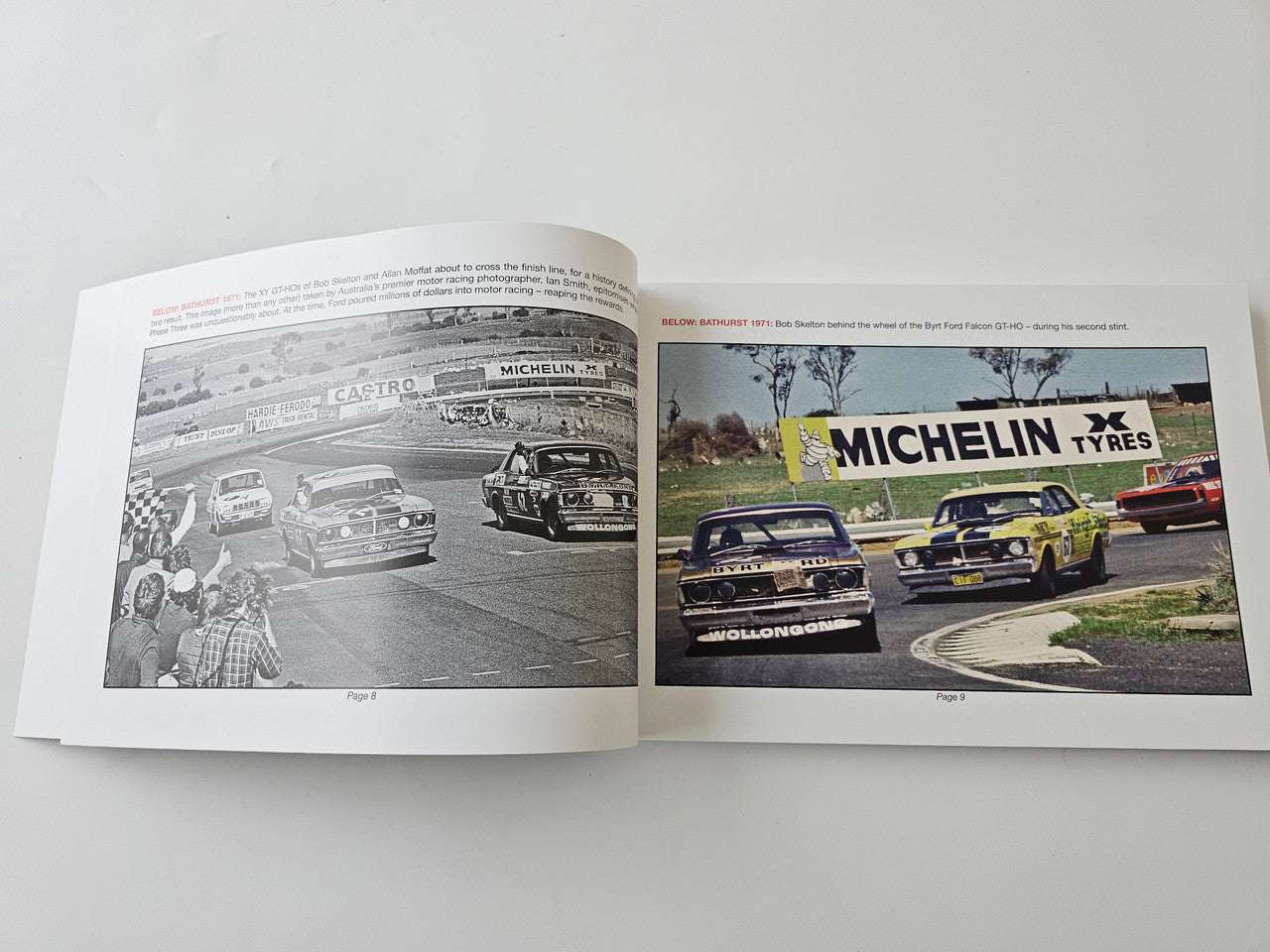 Paperback book open to spread with two car photos and MICHELIN tire text