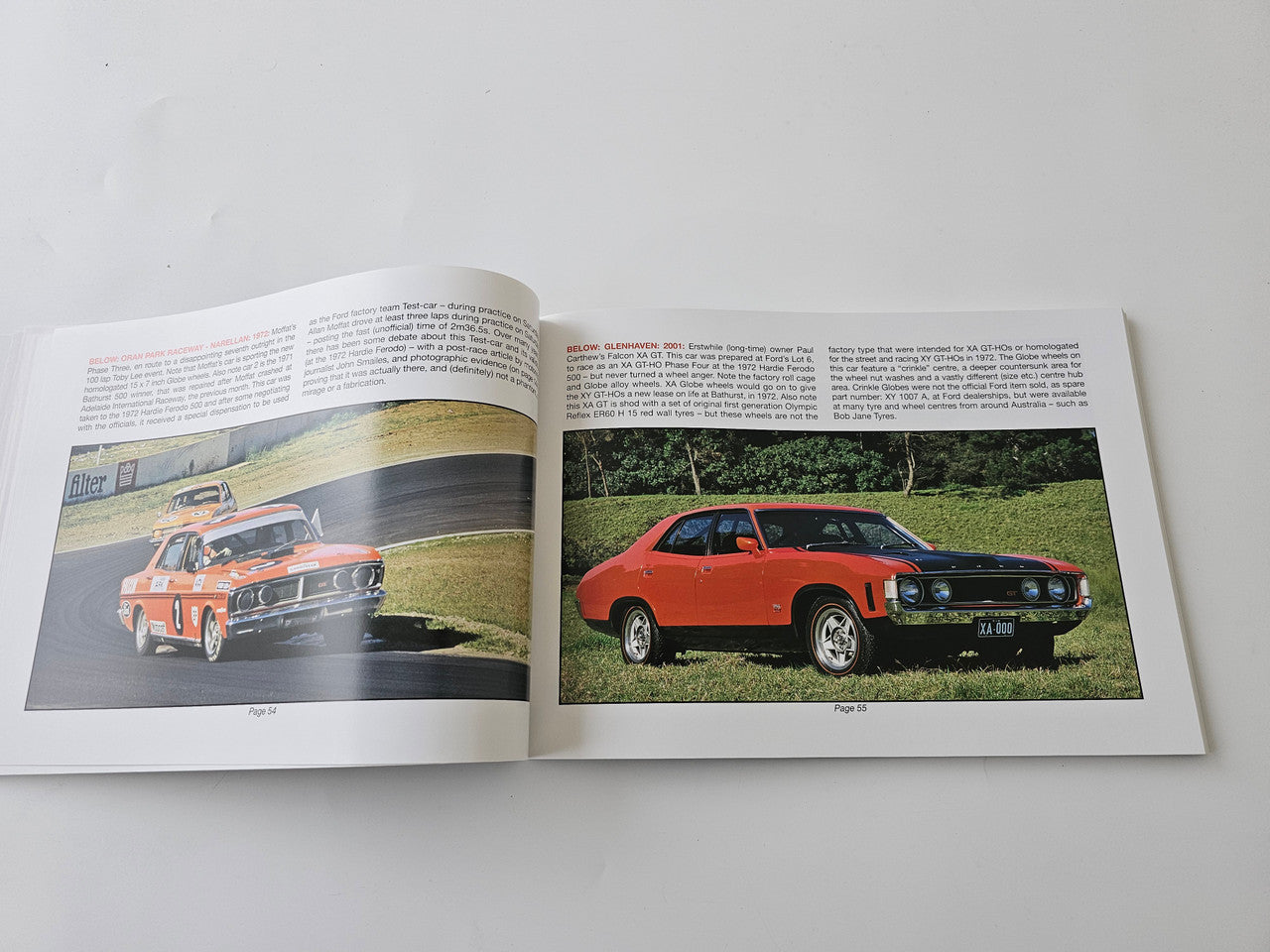 Automotive racing photo book, open pages with orange and red classic muscle cars