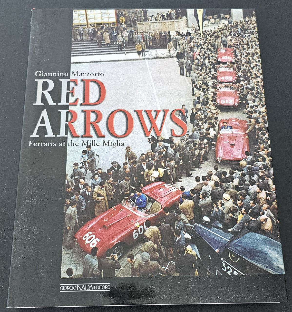 Hardcover book with red title 'RED ARROWS' and racing car photo on front cover