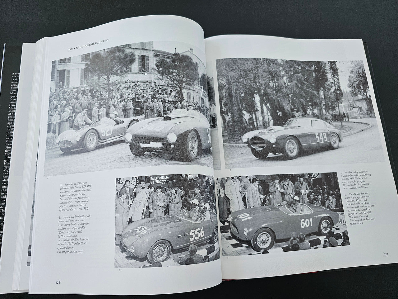 Open book spread with four black-and-white photos of vintage race cars
